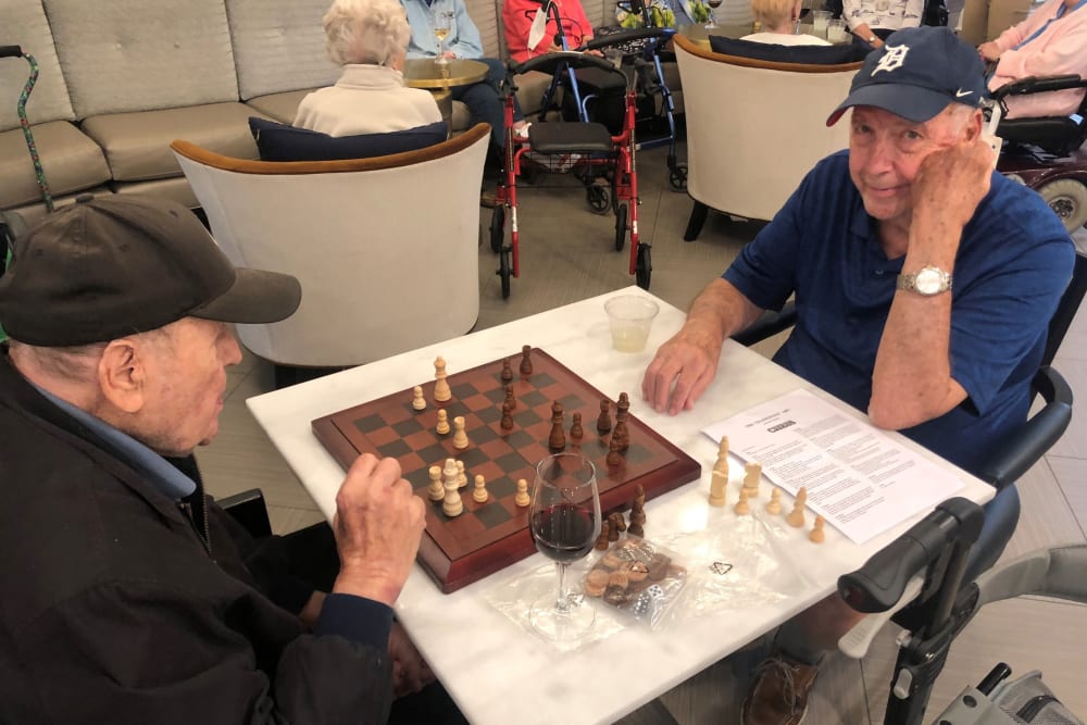 Residents enjoying a chess game together at Anthology of Burlington Creek in Kansas City, Missouri