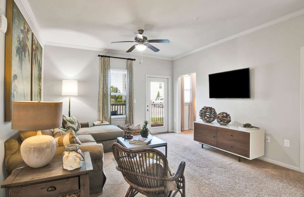 Living room with wall art and couch at The Crossings At Milestone in Pensacola, Florida