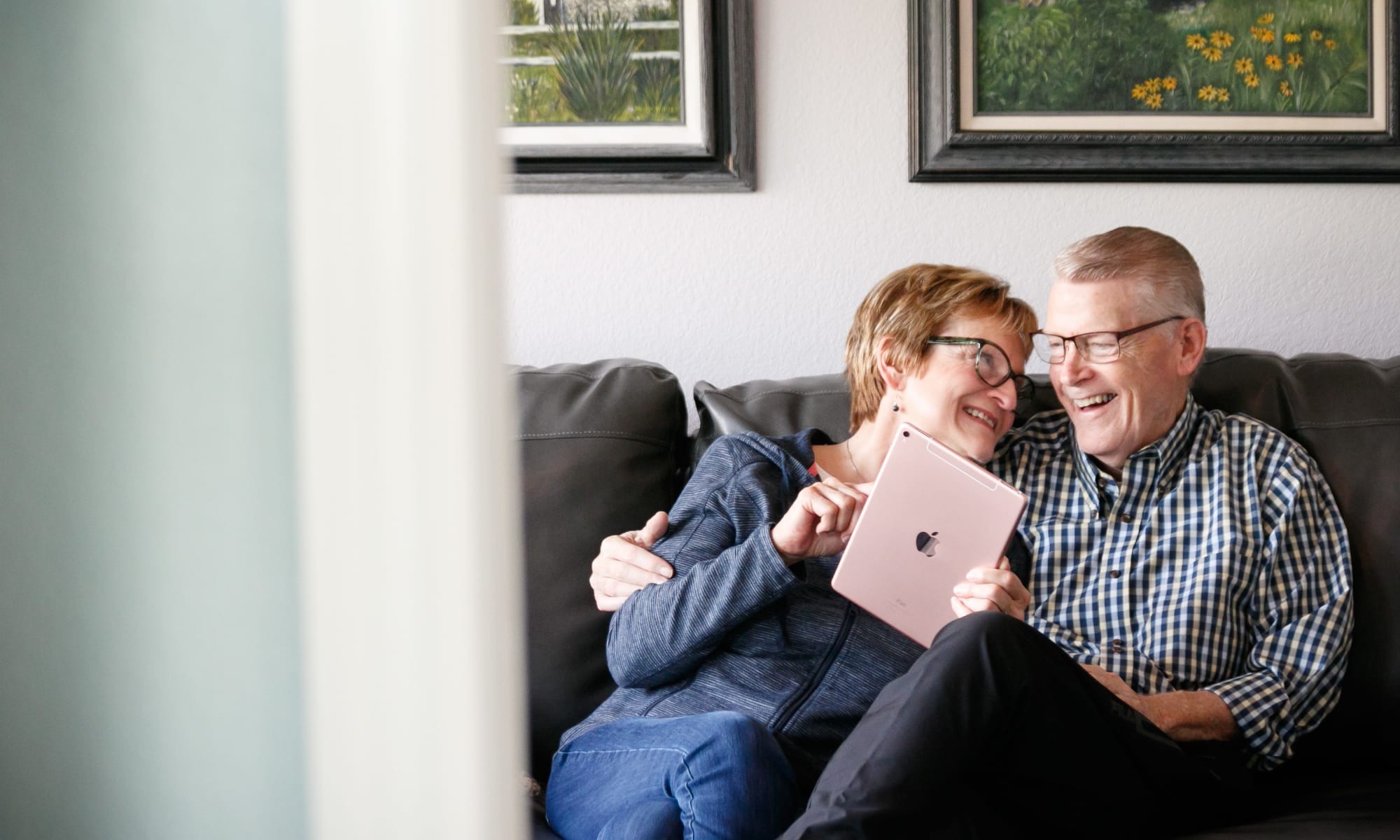 Senior couple holding a tablet and smiling