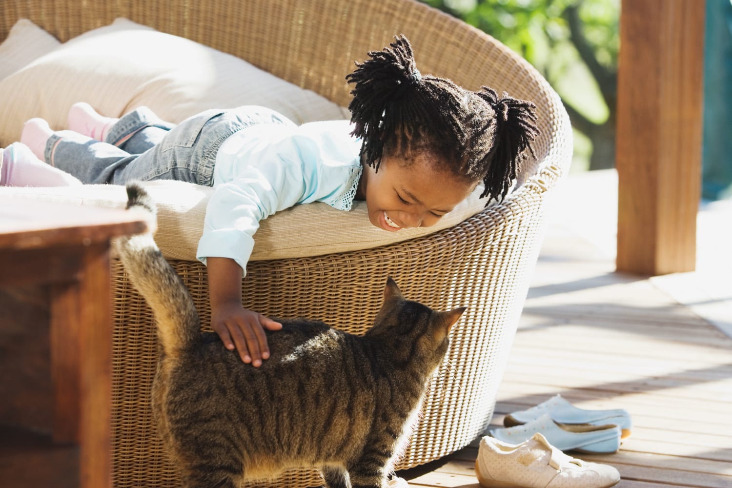 young girl playing with her cat at Country Ranch Apartments in Fort Collins, Colorado