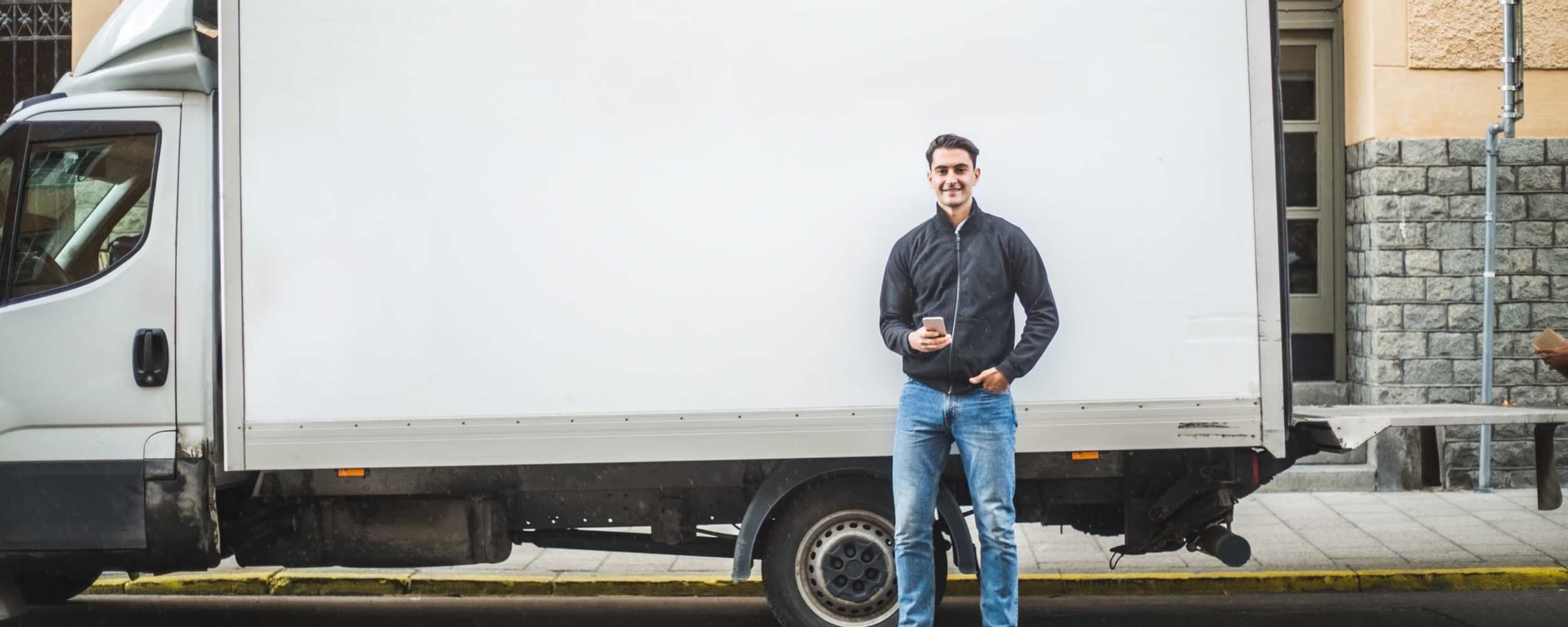 A man stands beside a moving truck at RoadRunner RV Storage, Roseville, California