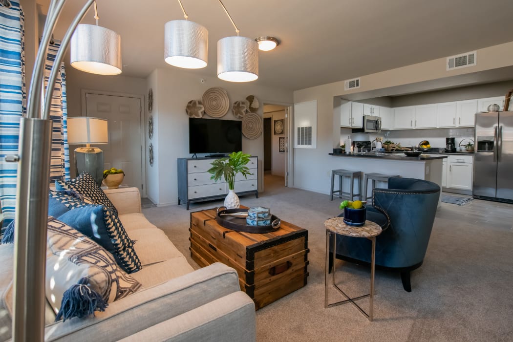 Living room and kitchen at Portico at Friars Creek Apartments in Temple, Texas