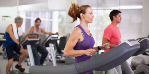 Residents doing cardio in well-equipped gym  at Clipper Cove in Tampa, Florida