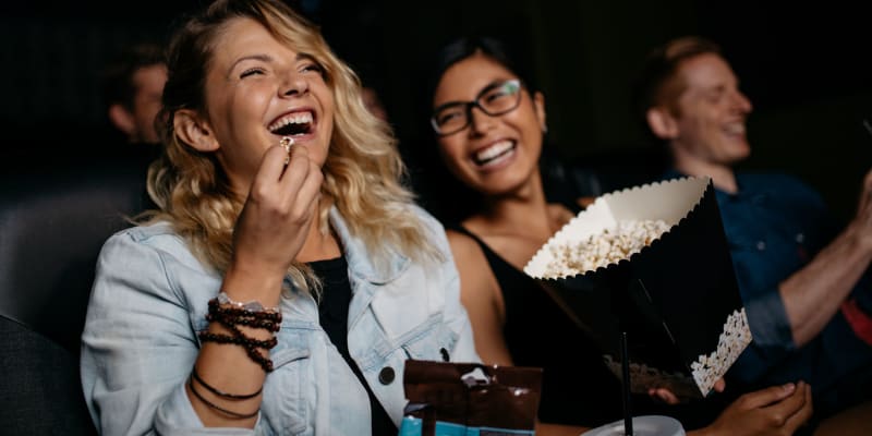 Residents eating popcorn and laughing at a movie theater near San Luis Rey in Oceanside, California