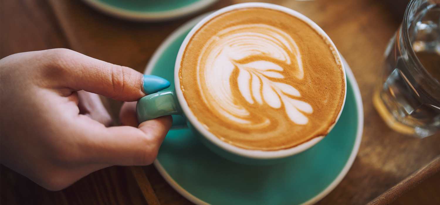 Resident enjoying a latte at Saratoga Place Apartments in Suffolk, Virginia