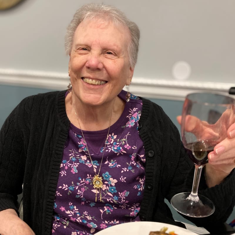 Resident dining with wine glass in hand at The Clinton Presbyterian Community in Clinton, South Carolina