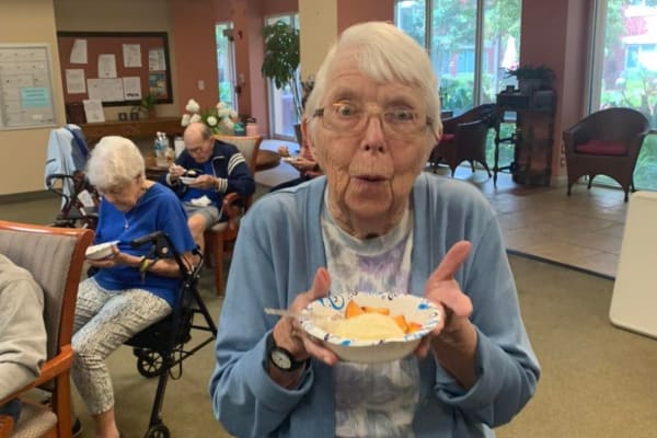 Resident displays bowl of peaches and ice cream at Wesley Haven Villa in Pensacola, Florida