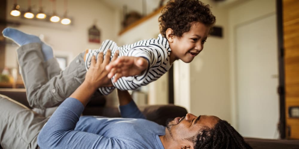 A father playing with his son at Vesta Creeks Run in North Charleston, South Carolina