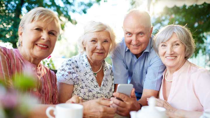 Four senior people taking a picture