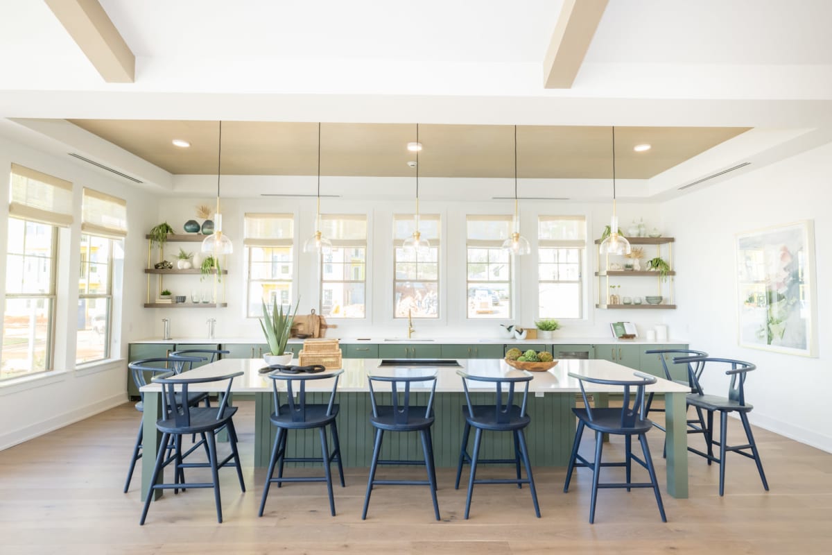 Indoor community area with large kitchen island and bar stools 