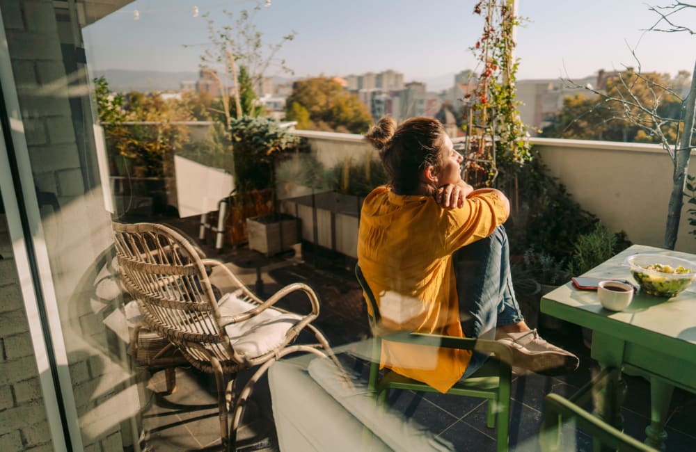 Resident taking in the gorgeous view from her private balcony at Montoya Garden in San Pablo, California