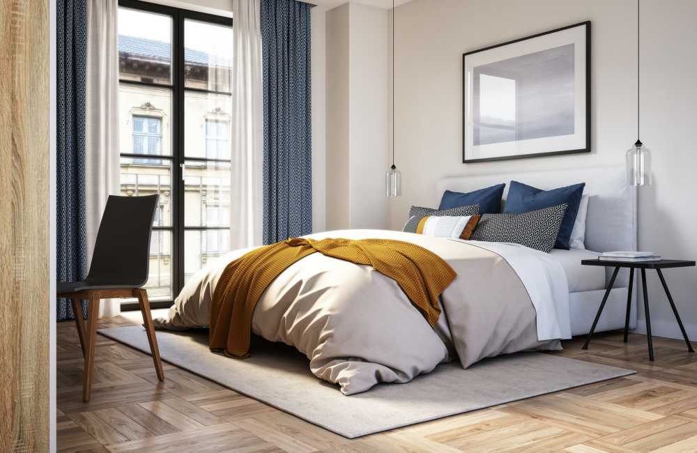 Well-furnished bedroom in a model apartment at The Oslo Apartments in Northglenn, Colorado