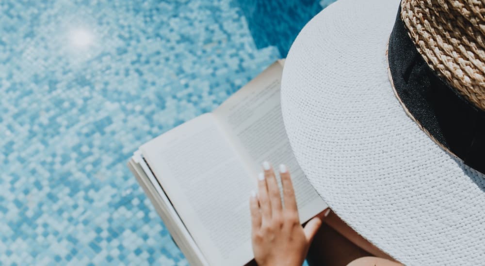 Resident reading, poolside at ila Hyde Park in Cincinnati, Ohio