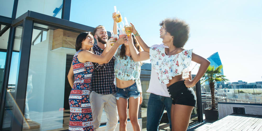 A group of friends toasting drinks at Indigo Champions Ridge in Davenport, Florida