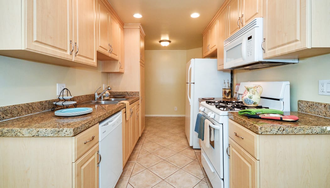 Gourmet kitchen with granite countertops in model home at IMT Beverly Arnaz in Los Angeles, CA