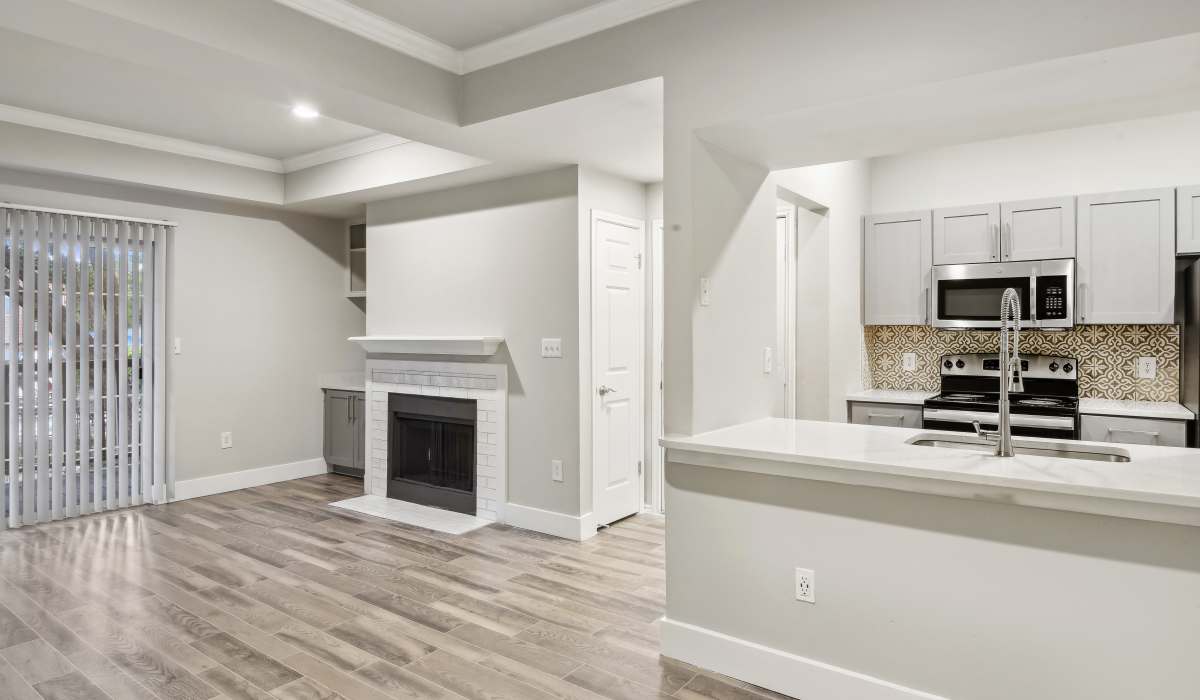 Modern unfurnished living room with wood-style flooring and fireplace at Charleston in San Antonio, Texas