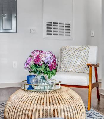 Cozy living area with accent chair and decor table at The Carlton At Lake Dexter in Winter Haven, Florida