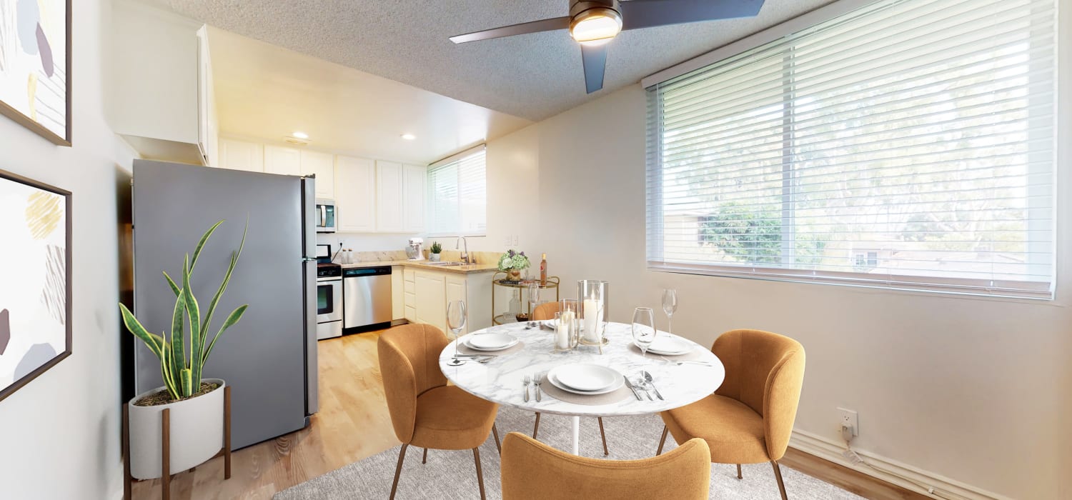 Dining room and kitchen in a two-bedroom apartment at Sunset Barrington Gardens in Los Angeles, California