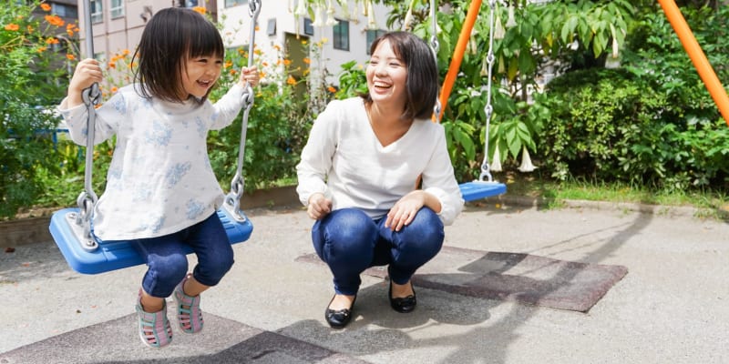 A resident and her child on the playground at a school near Harborview in Oceanside, California