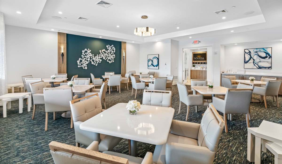 Seating area with tables and chairs at Solera at Avalon Trails in Delray Beach, Florida