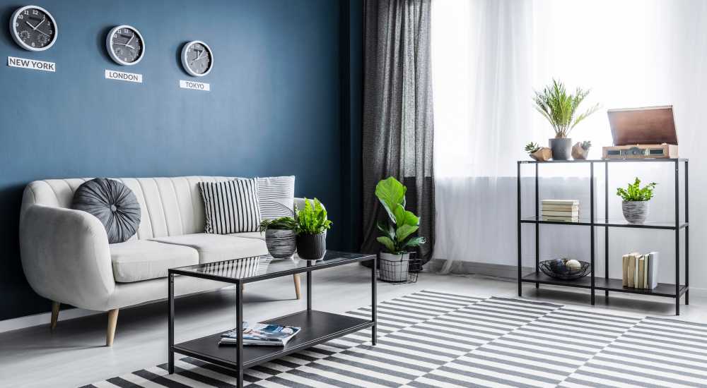 Cozy couch in a living room with carpet with windows at Brookwood Apartments in Columbia, Tennessee