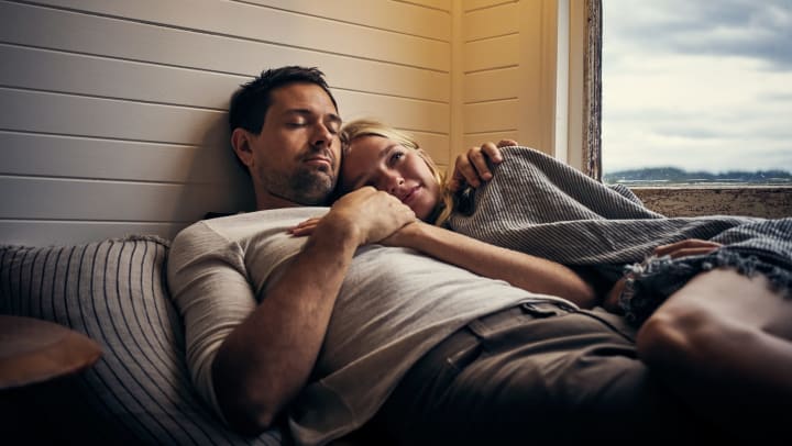 Young couple lying on a bed in a vacation home