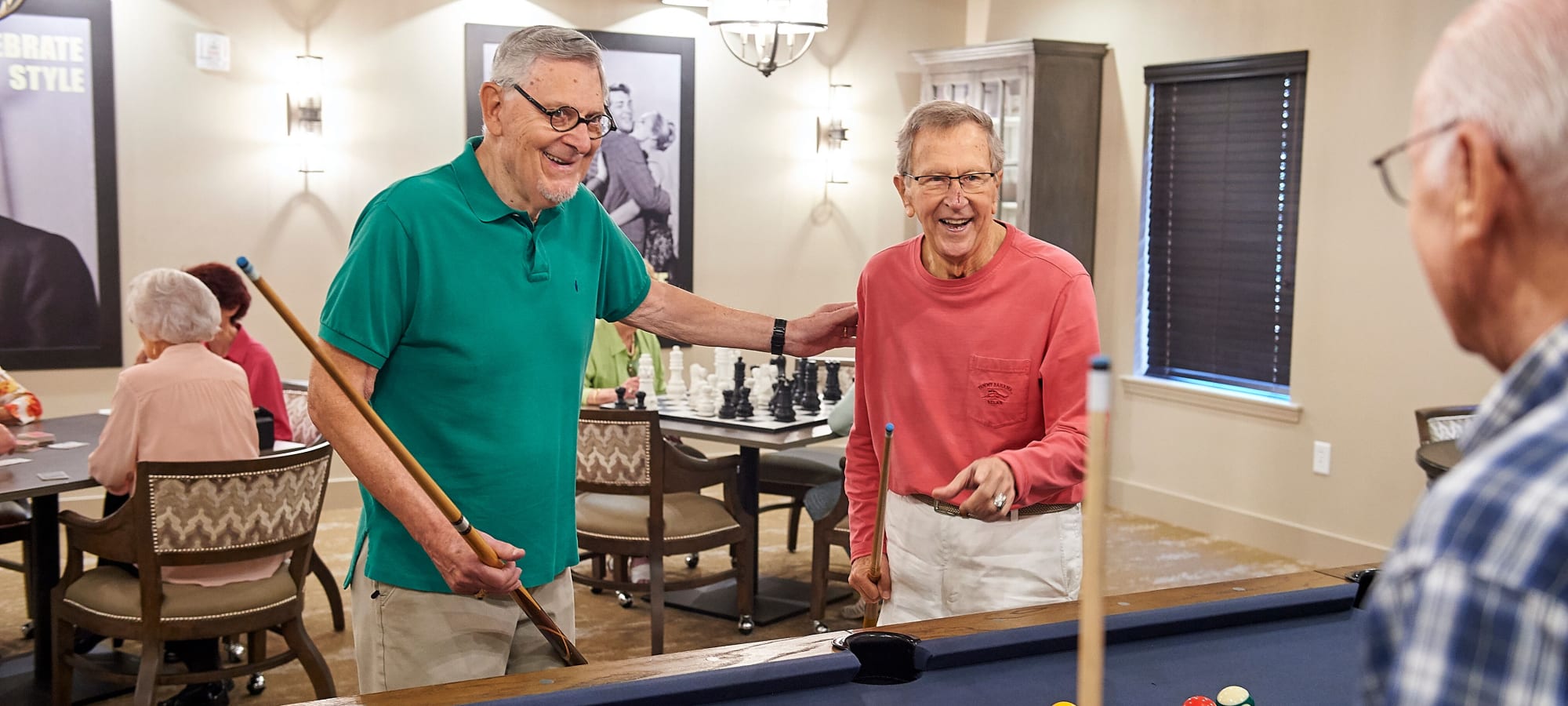 Residents playing pool at AgeWell Living