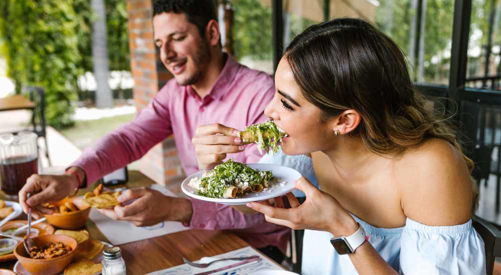 Resident couple having delicious food at a restaurant near The Warrick in Nashville, Tennessee