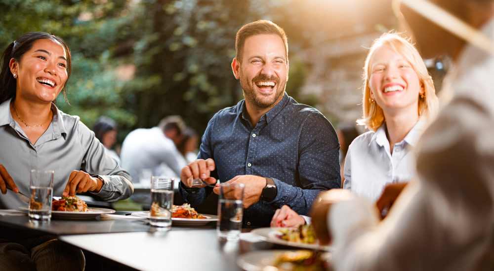 Friends having a meal at Woodlawn Lofts in Pittsburgh, Pennsylvania