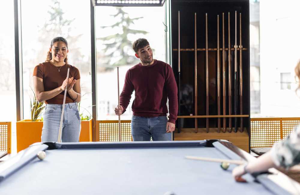 Residents playing pool table in clubhouse at Winchester Run in Oklahoma City, Oklahoma
