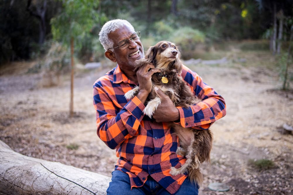 A resident petting his dog at Morris Glen in Alexandria, Virginia