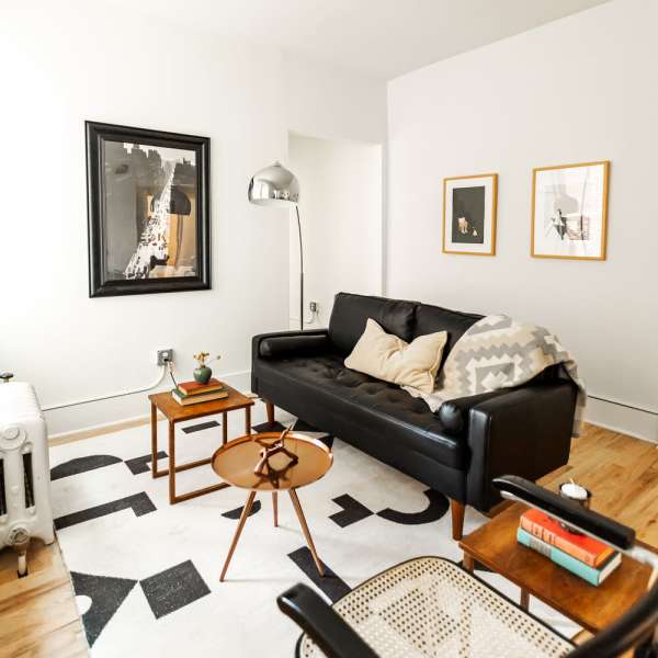 Living room with leather couch at Detroit Living in Detroit, Michigan