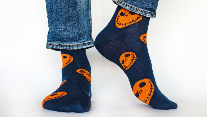 Closeup of black and orange Halloween-themed socks