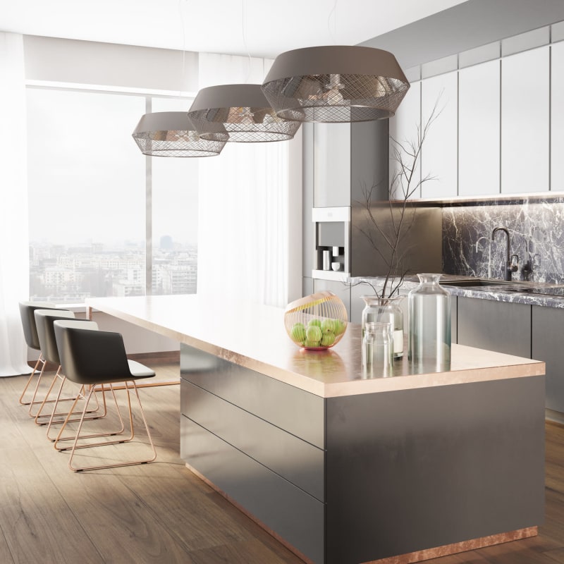 Ultra-modern kitchen with an island and expansive quartz countertop with bar seating in a model luxury apartment at Linda Vista Senior in Los Angeles, California