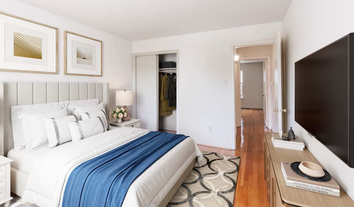 Bedroom with blue blanket at Landmark at Gayton Apartments in Richmond, Virginia
