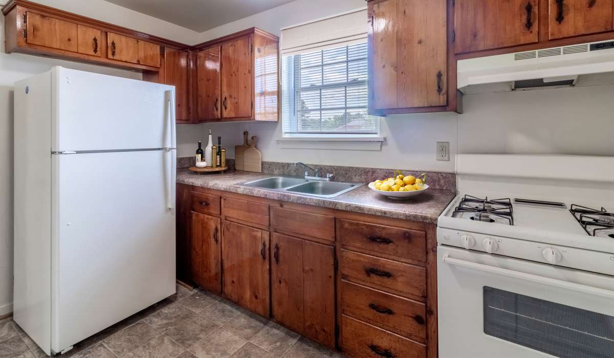 Kitchen with wooden cabinets at Landmark at Gayton Apartments in Richmond, Virginia