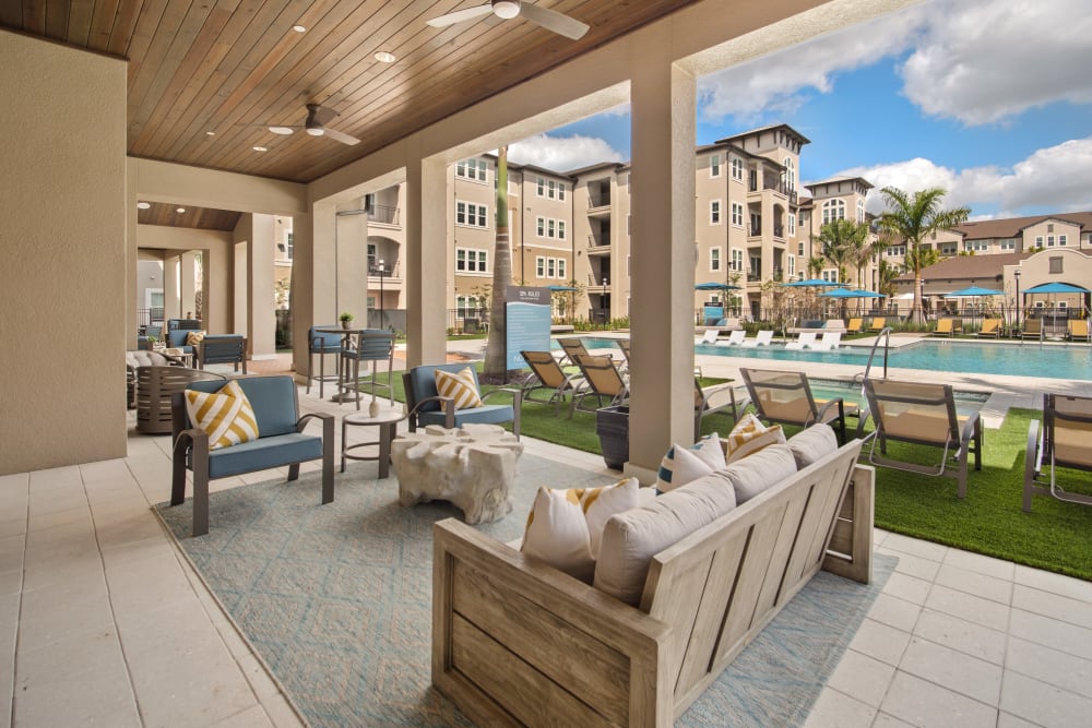 Outdoor lounge area outside of the clubhouse at Murano at Three Oaks in Fort Myers, Florida