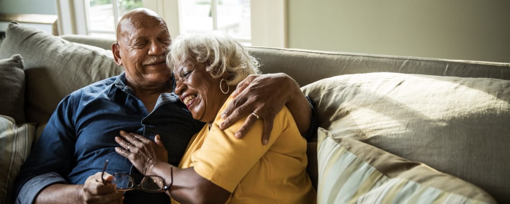 A man and woman embracing at at Ridgeline Management Company senior living property