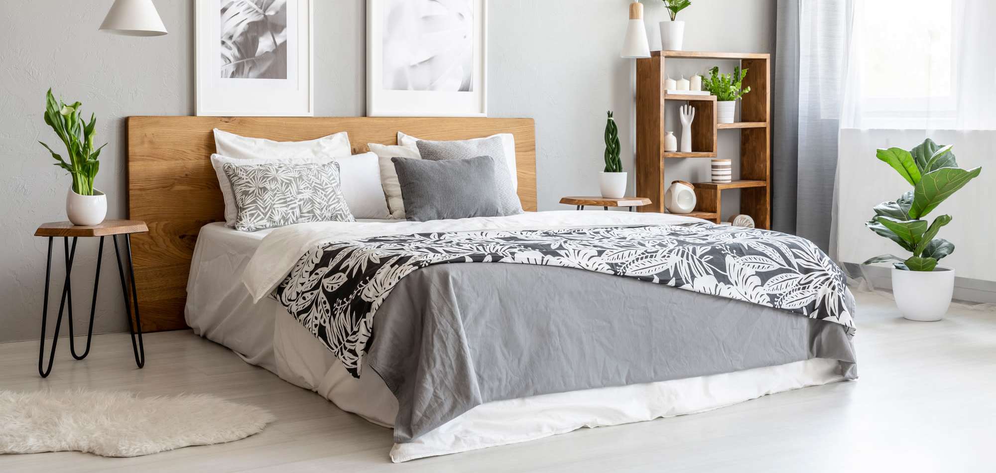 Gray bedding with patterned throw at Avia Lofts at Maple Road in Amherst, New York