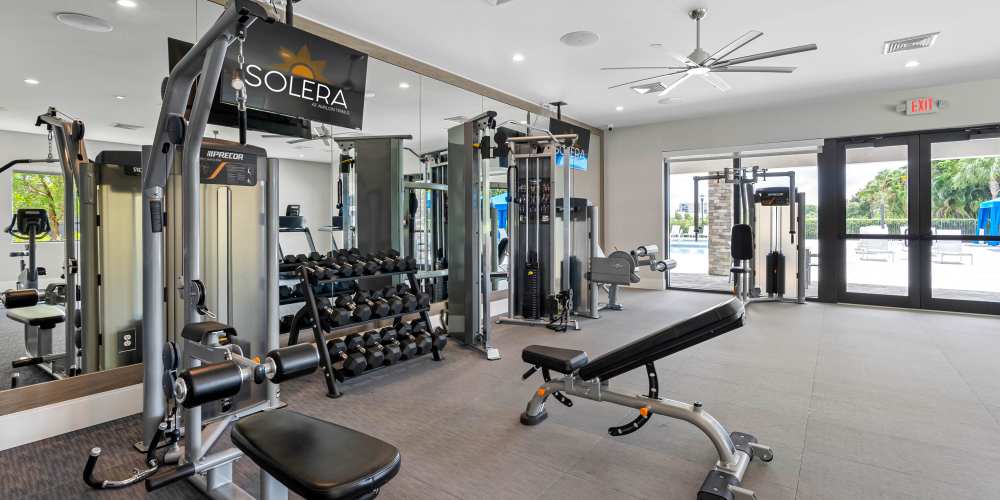 Weightlifting equipment and benches at Solera at Avalon Trails in Delray Beach, Florida