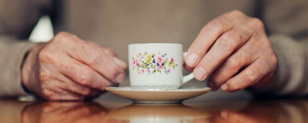 A resident drinking tea at Peaks at Millcreek in Salt Lake City, Utah