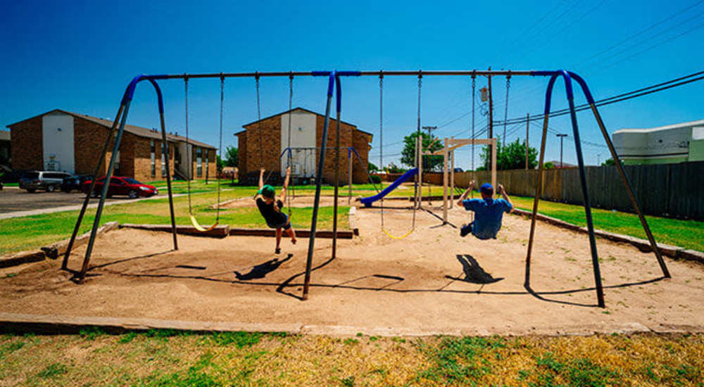 Residents swinging at Cross Timbers At Grand Street in Amarillo, Texas