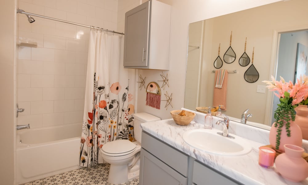 Cute bathroom with large mirror at 24Hundred Apartments in Oklahoma City, Oklahoma