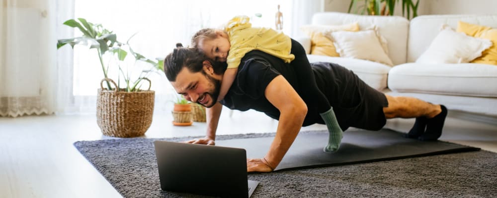 Resident doing pushups with his kid on his back at The Main in Evanston, Illinois