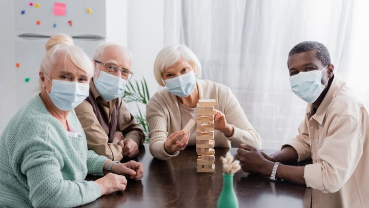 Residents with mask smiling and playing games