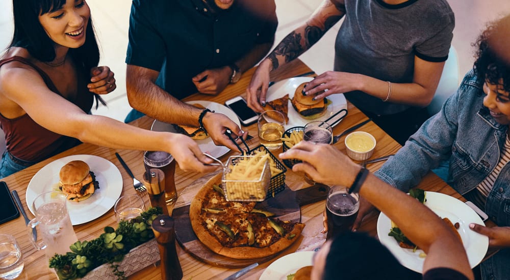 A group of people sharing food in a restaurant near Foundry Yards in Birmingham, Alabama