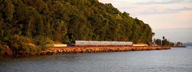 Awesome train going along the water near Eastgold Westchester in Dobbs Ferry, New York