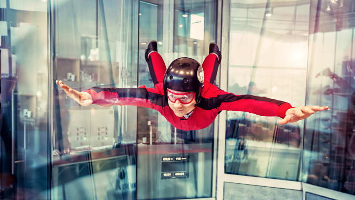 A man floating in air at an indoor skydiving venue in Frisco, Texas