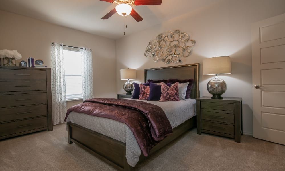 Bedroom with a ceiling fan at Stonehorse Crossing Apartments in Oklahoma City, Oklahoma