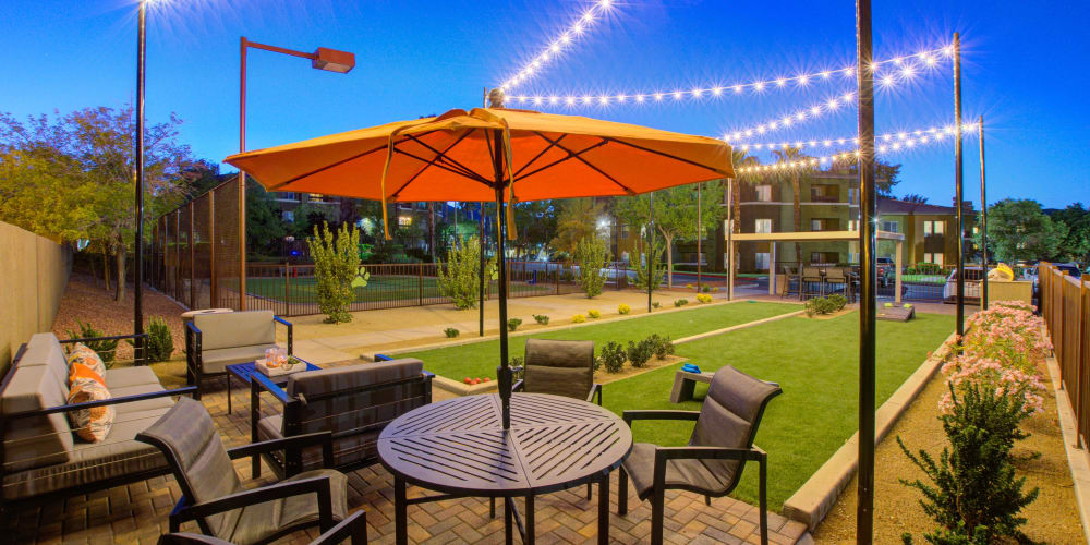 Outdoor seating with lawn games at Falling Water Apartments in Las Vegas, Nevada